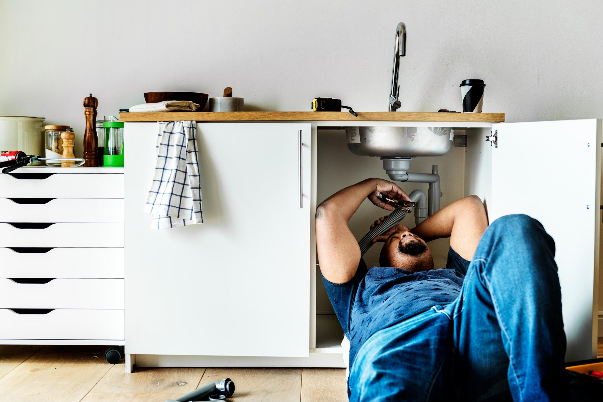 Plumber fixing a kitchen sink